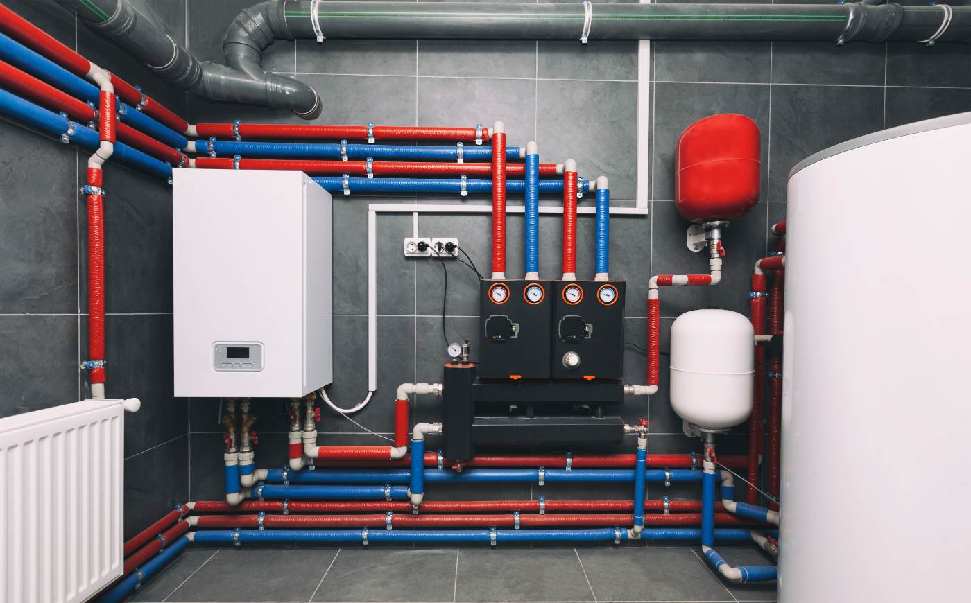 Whole-home water system showing softener tank, manifolds and insulated supply lines